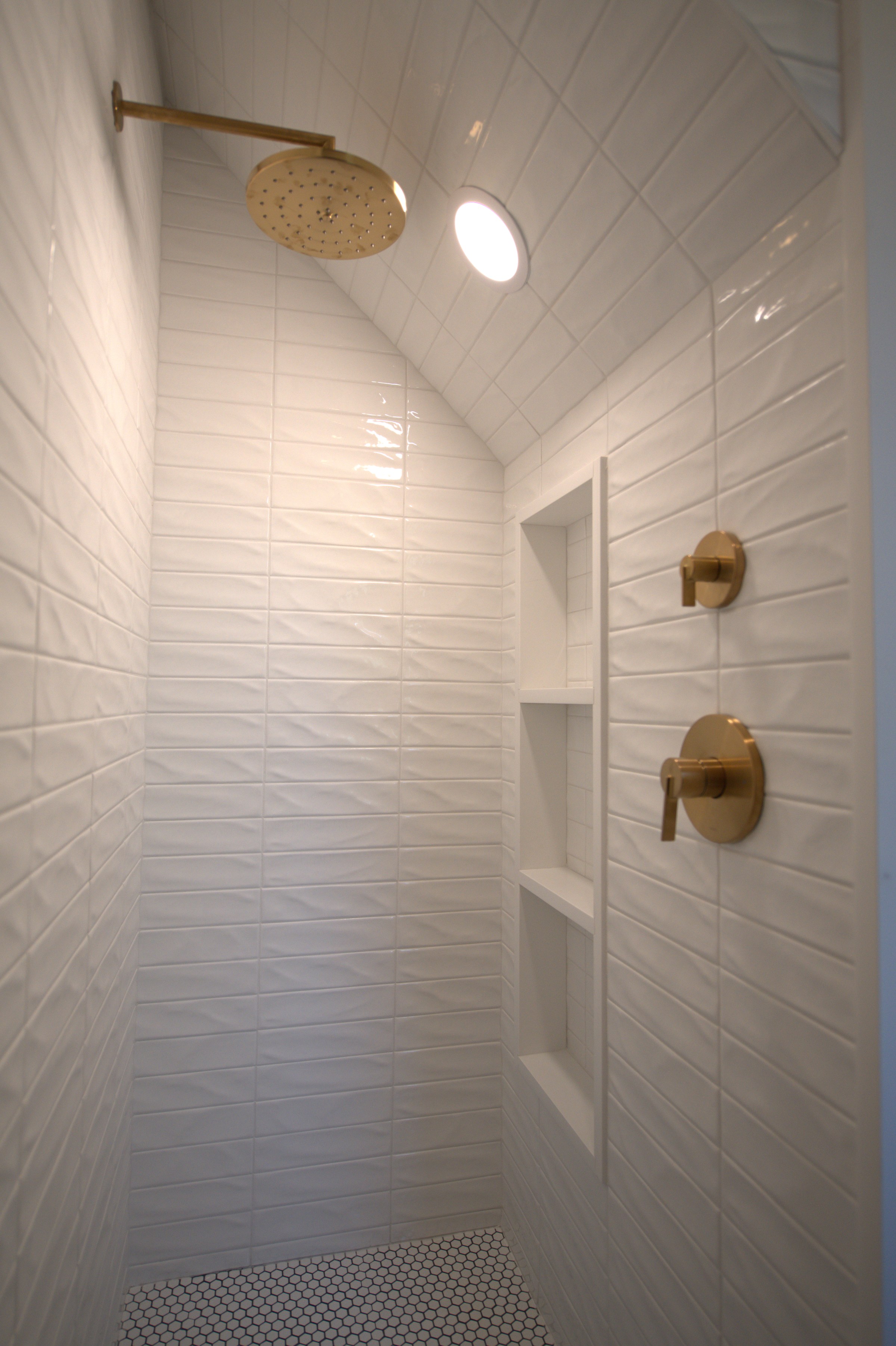 Shower niche with brass shower fixtures