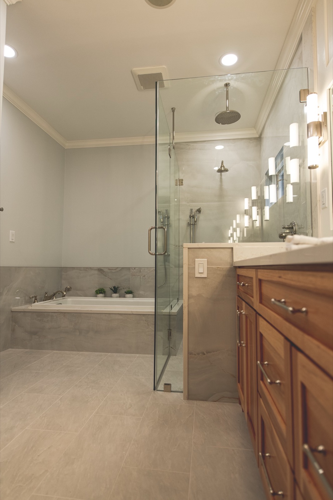 Bathroom corner detail with tub filler and large-format tile